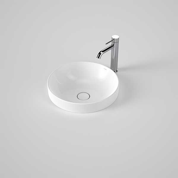 Caroma Liano II round white inset basin with thin rim and chrome tap on a grey surface