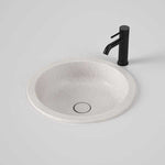 Caroma Liano II round under counter basin in matte speckled white with matching pop-up waste, shown with black tap
