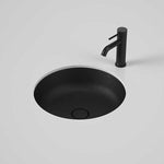 Caroma Liano II round matte black under-counter basin with matching black mixer tap on a light vanity surface