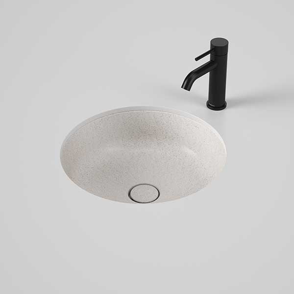 Caroma Liano II round under/over counter basin in matte speckled finish with black mixer tap shown above the vanity cut-out