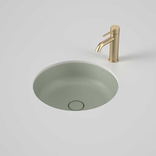 Caroma Liano II round under/over counter basin in matte green, shown with a brushed brass mixer tap and waste, top view