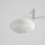 Caroma Liano II round matte white undercounter basin with matching ceramic waste and a chrome mixer tap above