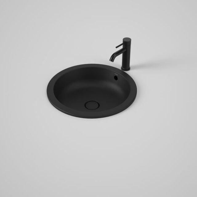 Caroma Liano II round matte black basin with overflow, shown with black mixer tap on a white benchtop