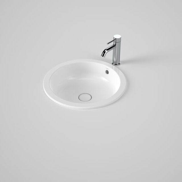 Caroma Liano II round white ceramic basin with overflow, shown under-counter with chrome tap on benchtop