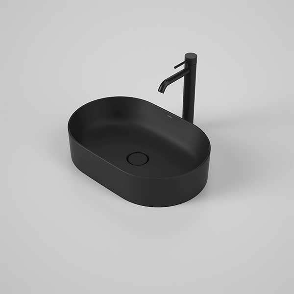 Caroma Liano II matte black oval above counter basin with matching tap on a grey background