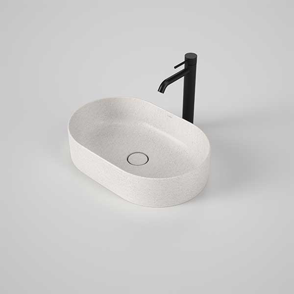 Caroma Liano II oval above-counter basin in matte speckled white, shown with black mixer tap on a vanity-style setting