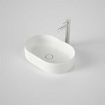 Caroma Liano II matte white oval above-counter basin with thin rim and centre waste shown with mixer tap on grey background
