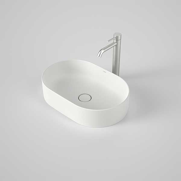 Caroma Liano II matte white oval above-counter basin with thin rim and centre waste shown with mixer tap on grey background