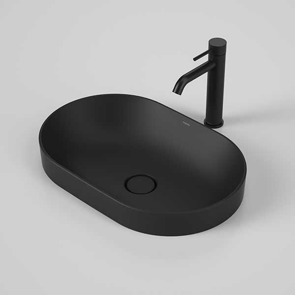 Caroma Liano II matte black pill inset basin with matching pop-up waste and black mixer tap brassware shown on a plain background