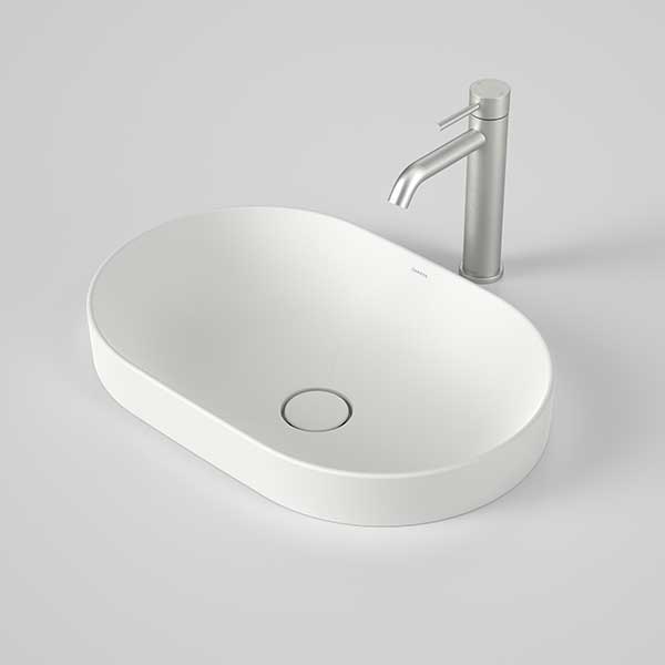 Caroma Liano II oval inset basin in matte white with thin rim and matching plug, shown with chrome mixer tap