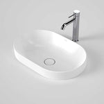 Caroma Liano II white pill inset basin with thin rim and pop-up waste, shown with chrome tap on a grey background