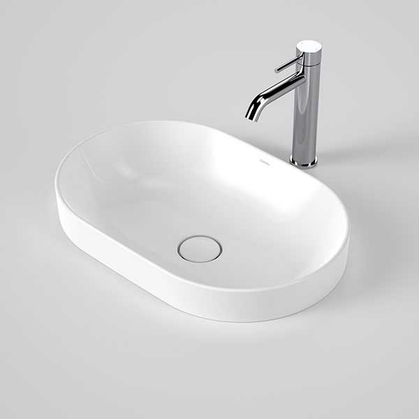 Caroma Liano II white pill inset basin with thin rim and pop-up waste, shown with chrome tap on a grey background