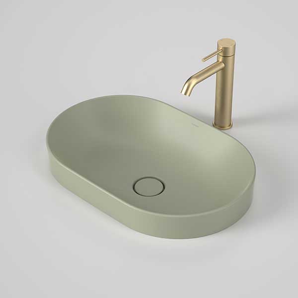 Caroma Liano II oval inset basin in matte green with matching waste and gold tap shown on a grey background