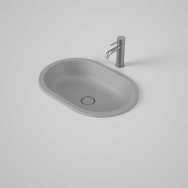 Caroma Liano II matte grey oval under/over counter basin with thin rim and matching waste, shown with mixer tap on white background