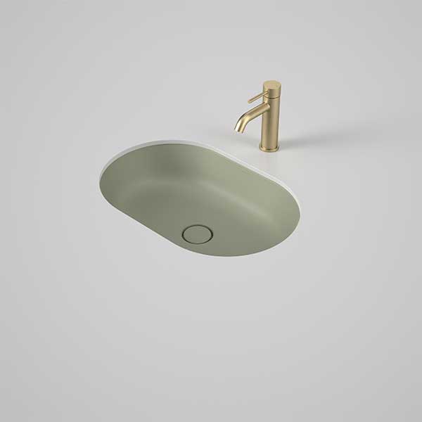 Caroma Liano II pill undercounter basin in matte green, oval ceramic vanity basin with matching waste and tap shown on a bench