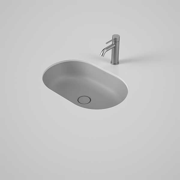 Caroma Liano II matte grey pill under counter basin with thin rim and pop-up waste, shown with mixer tap in white vanity.