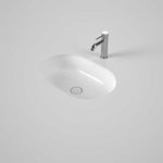Caroma Liano II white oval under counter basin with thin rim and chrome mixer tap shown in a vanity cut-out