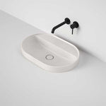 Caroma Liano II oval inset basin in matte speckled finish, with tap landing and black wall-mounted tapware