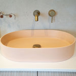 Caroma Liano II brushed brass bath/shower mixer wall outlet above a freestanding bath in a bathroom setting