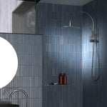 Caroma Liano II compact twin shower in chrome, with overhead rain shower and hand shower in a blue tiled bathroom