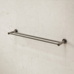 Caroma Liano II double towel rail in gunmetal, wall-mounted on light stone tiles