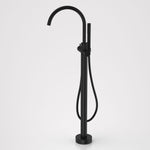 Caroma Liano II freestanding bath filler with hand shower in matte black, floor-mounted with gooseneck spout and hose