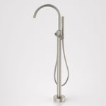 Caroma Liano II freestanding bath filler with hand shower in brushed nickel, floor mounted with gooseneck spout and round base