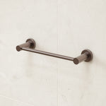 Caroma Liano II brushed bronze hand towel rail on white bathroom tiles