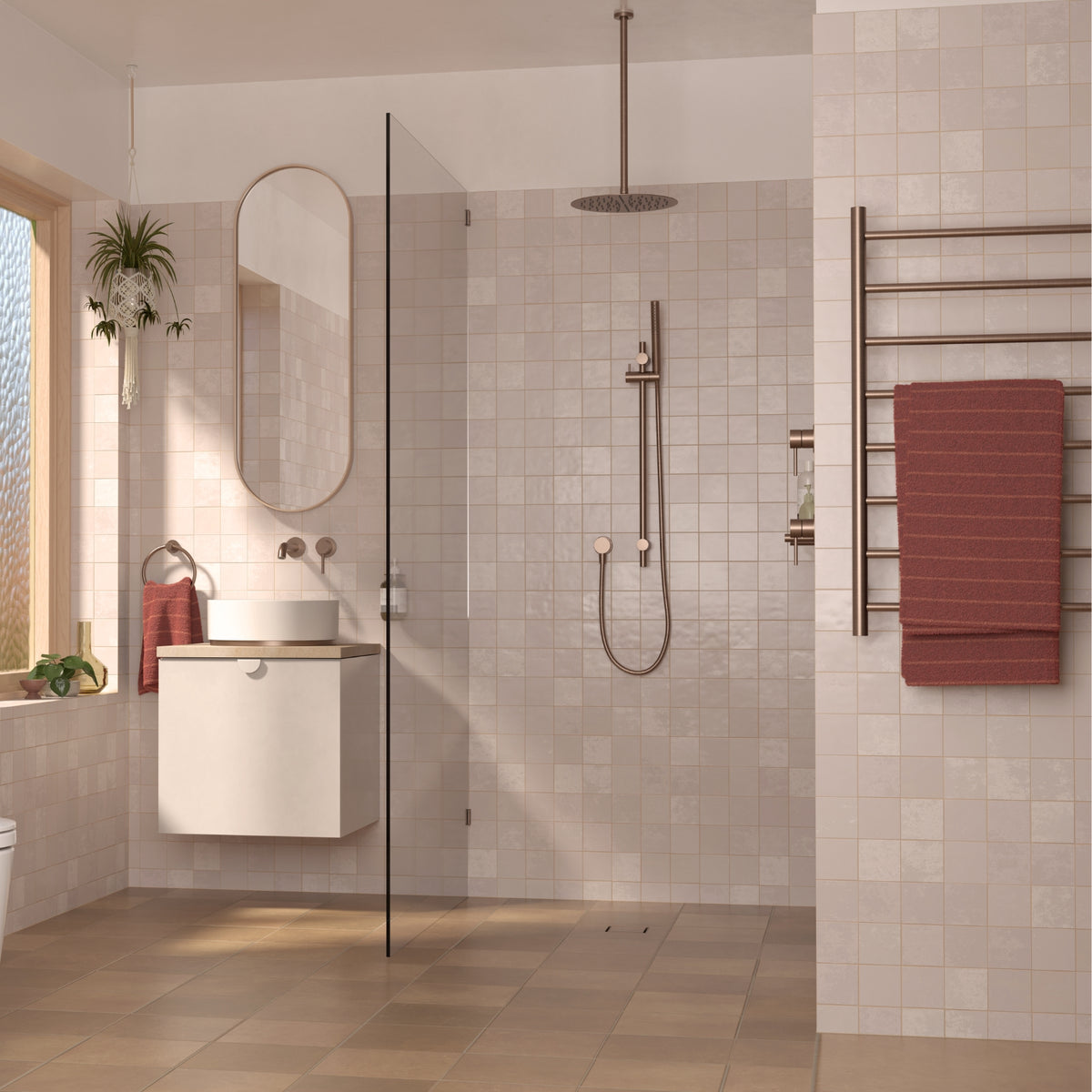 Caroma Liano II heated towel ladder in brushed bronze, shown mounted with a towel in a tiled bathroom