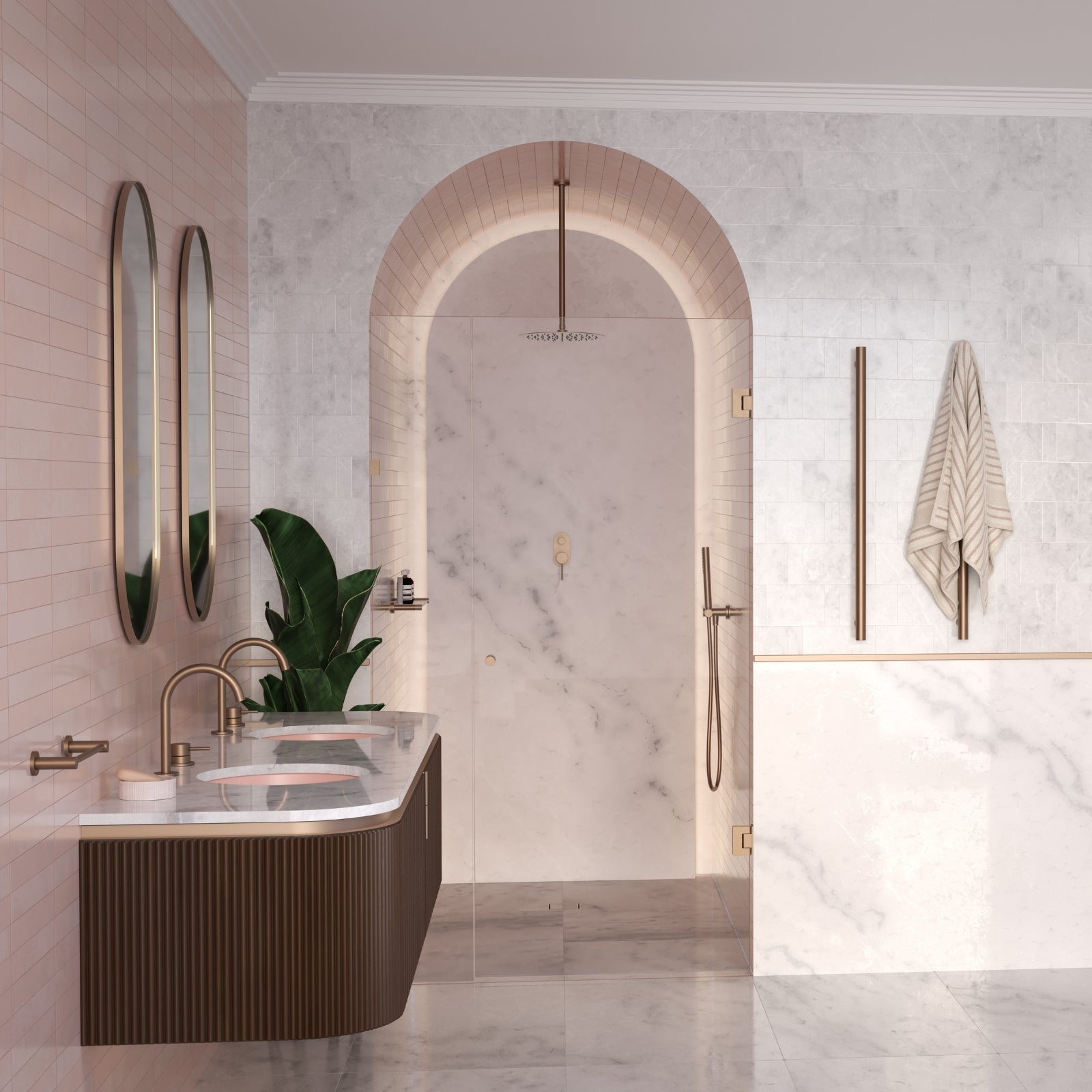 Caroma Liano II vertical heated towel rail in brushed bronze, shown in a modern bathroom on the wall with a towel hanging on it