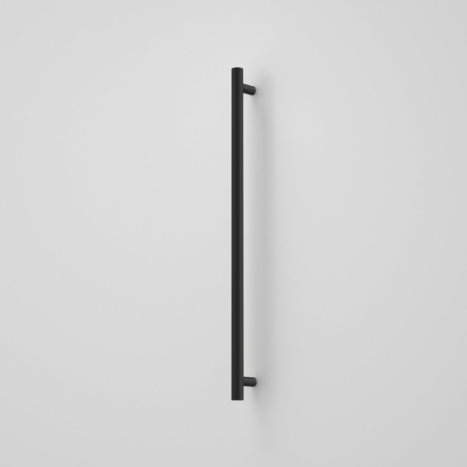 Caroma Liano II vertical heated towel rail in matte black, single round bar on a white wall
