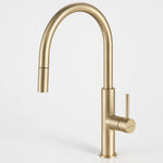 Caroma Liano II pull out sink mixer in brushed brass, shown front on with tall curved gooseneck spout and side lever.