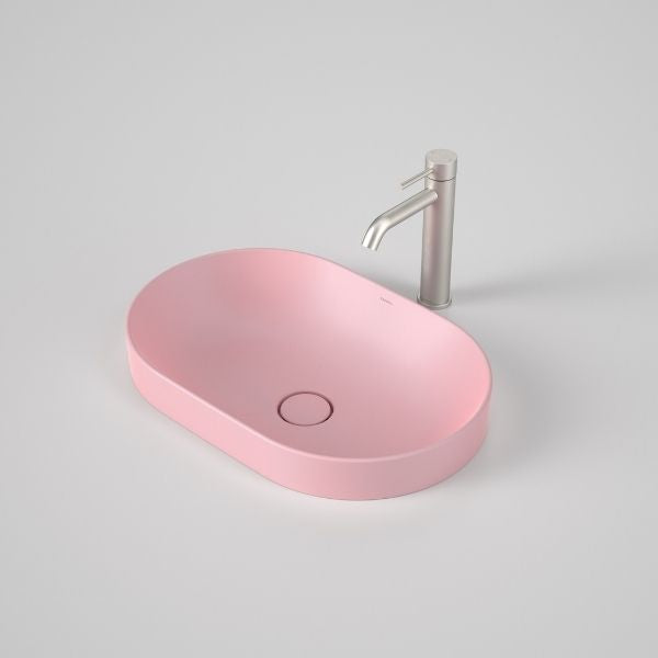 Caroma Liano II matte pink pill inset basin with matching waste and chrome mixer tap, oval front view
