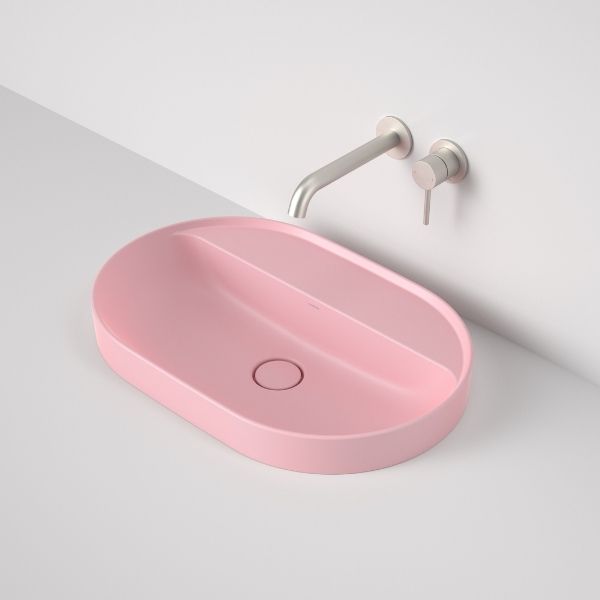 Caroma Liano II matte pink oval inset basin with tap landing and 0 tap hole, shown with wall-mounted mixer tap