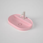 Caroma Liano II oval inset basin in matte pink with tap landing and single tap hole, shown with mixer tap on top