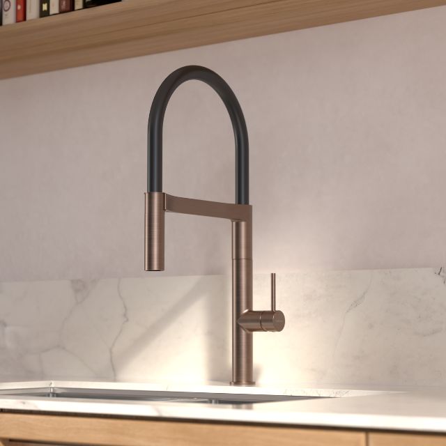 Caroma Liano II pull down sink mixer in brushed bronze with black flexible hose, shown installed in a kitchen sink bench