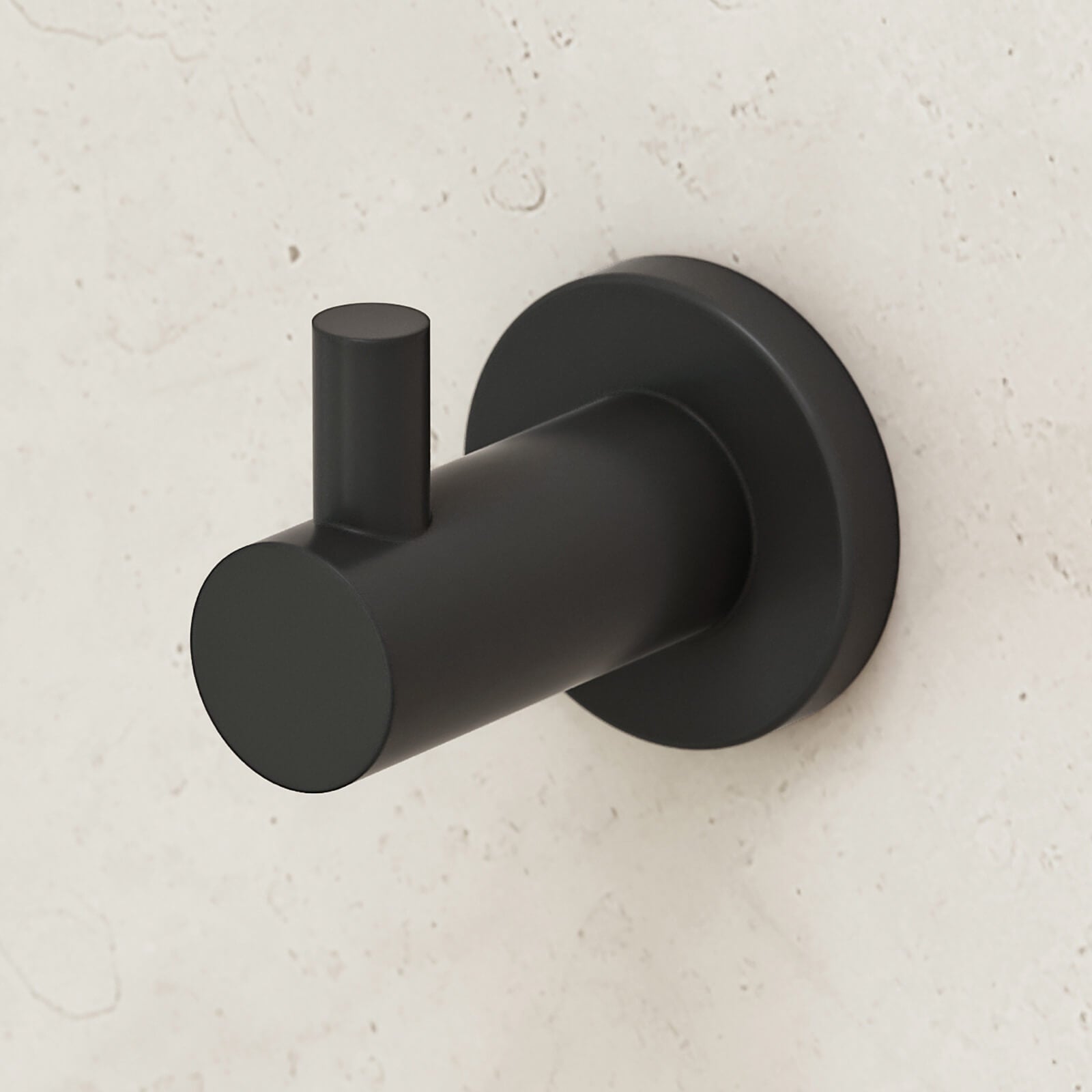 Caroma Liano II matte black robe hook with round wall plate on a light stone bathroom wall