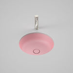 Caroma Liano II round matte pink under counter basin with matching pop-up waste, front view on grey background