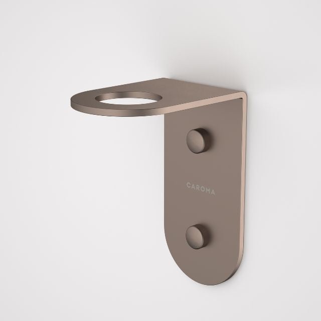 Caroma Liano II wall-mounted soap bottle holder in brushed bronze, side view with round top ring and concealed fixings