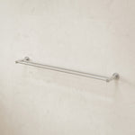 Caroma Liano II double towel rail in brushed nickel, wall-mounted on light tiled bathroom wall
