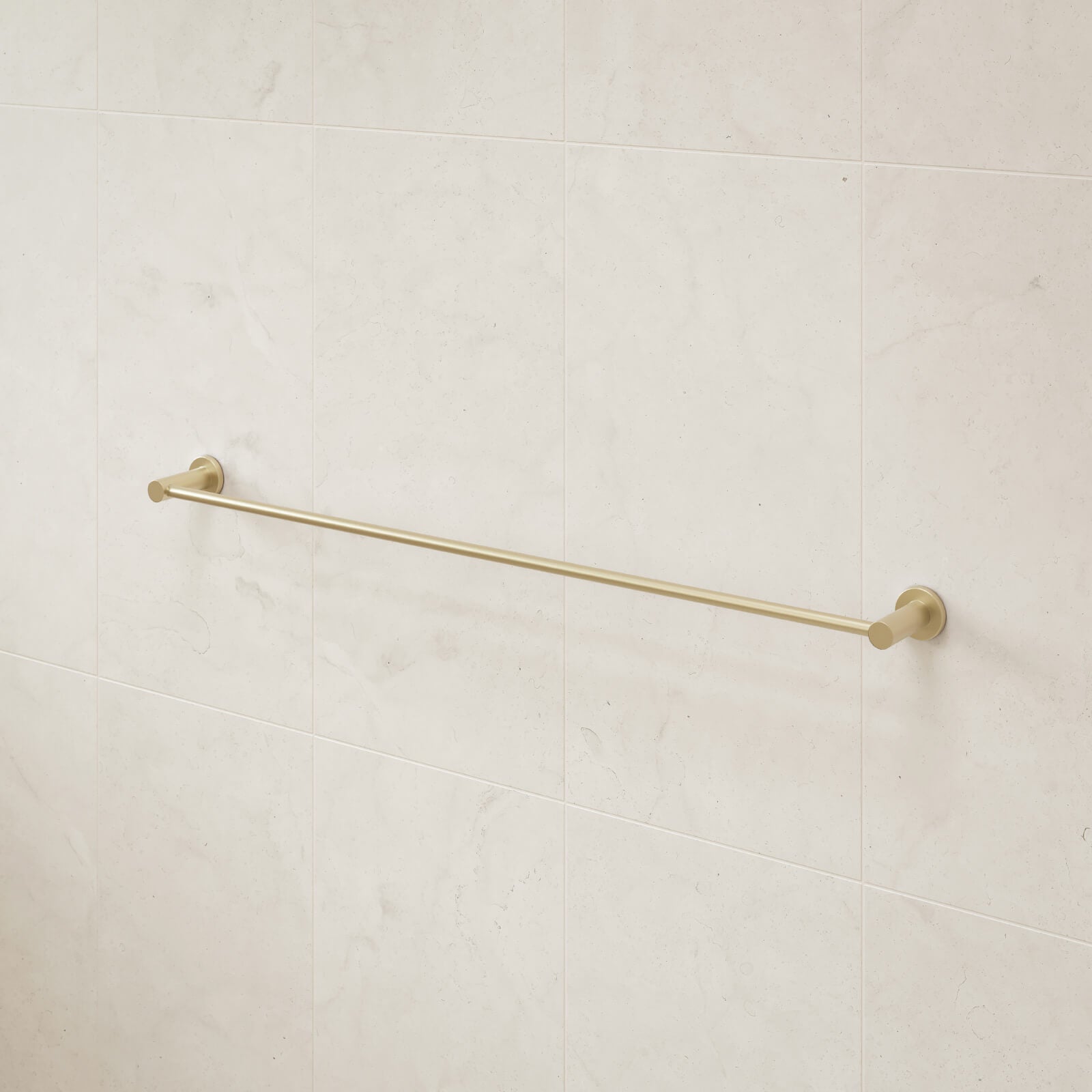Caroma Liano II single towel rail in brushed brass on a light tiled bathroom wall, wall-mounted horizontal bar view