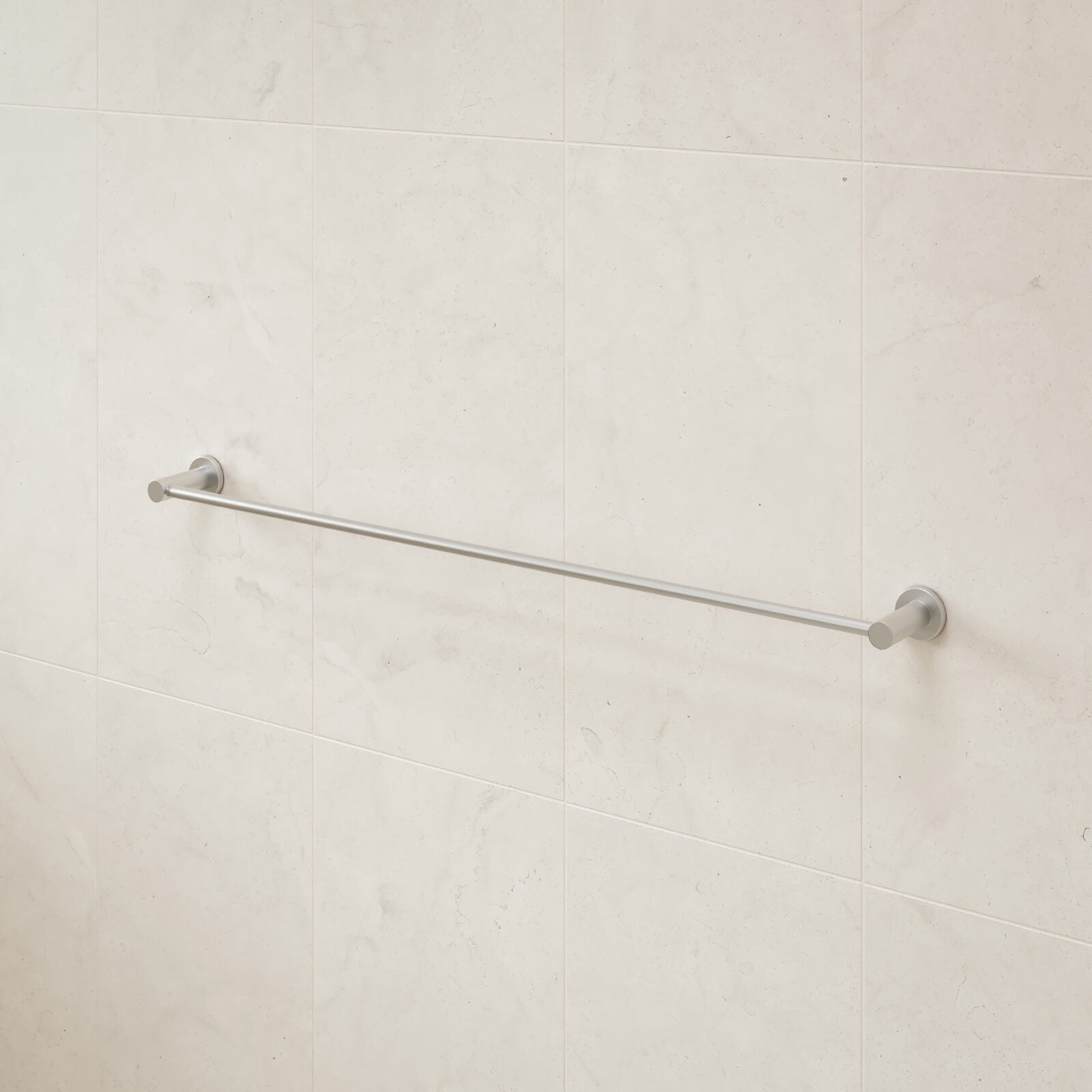 Caroma Liano II single towel rail in brushed nickel, wall-mounted on pale bathroom tiles