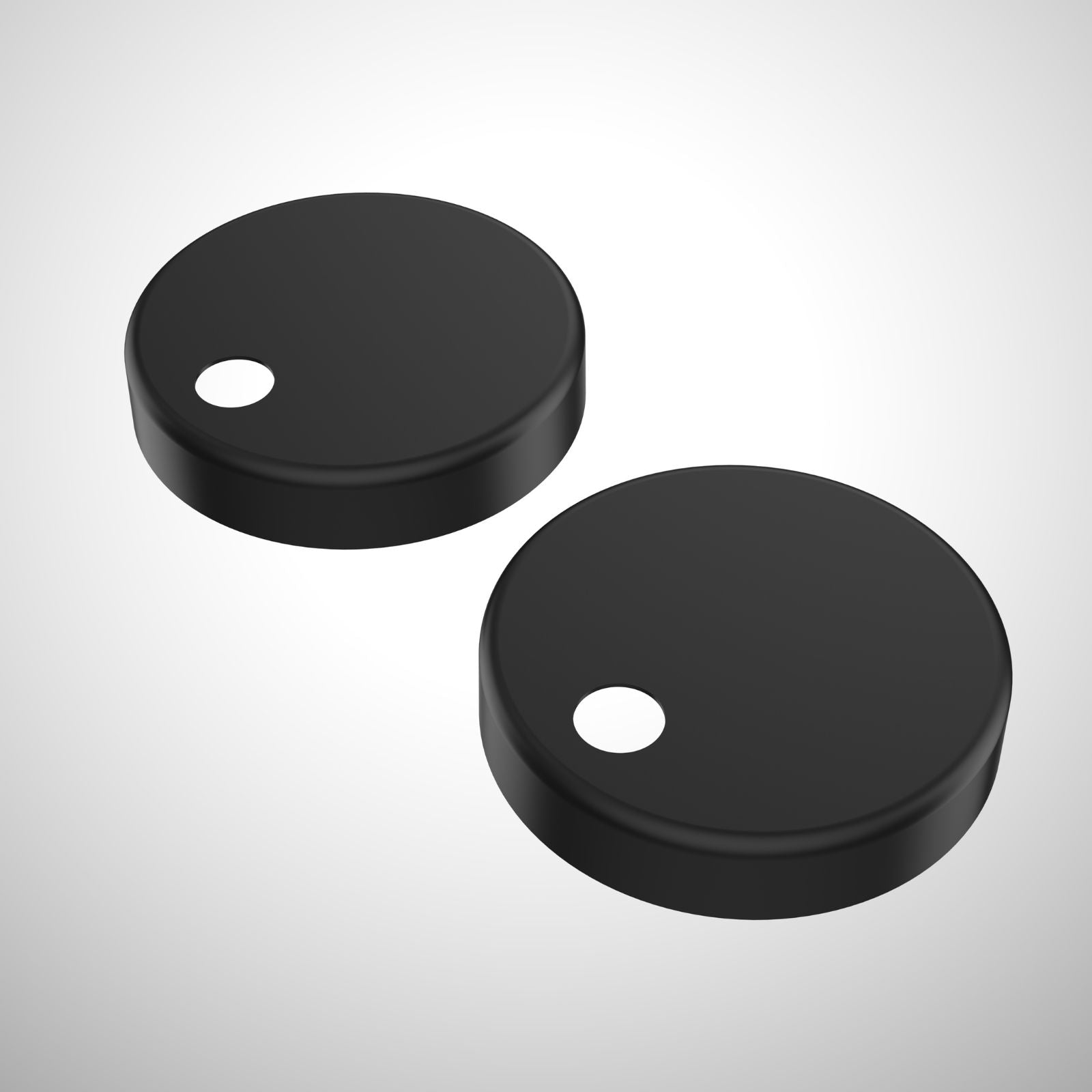 Caroma toilet seat hinge caps in matte black, shown as a pair on a white background
