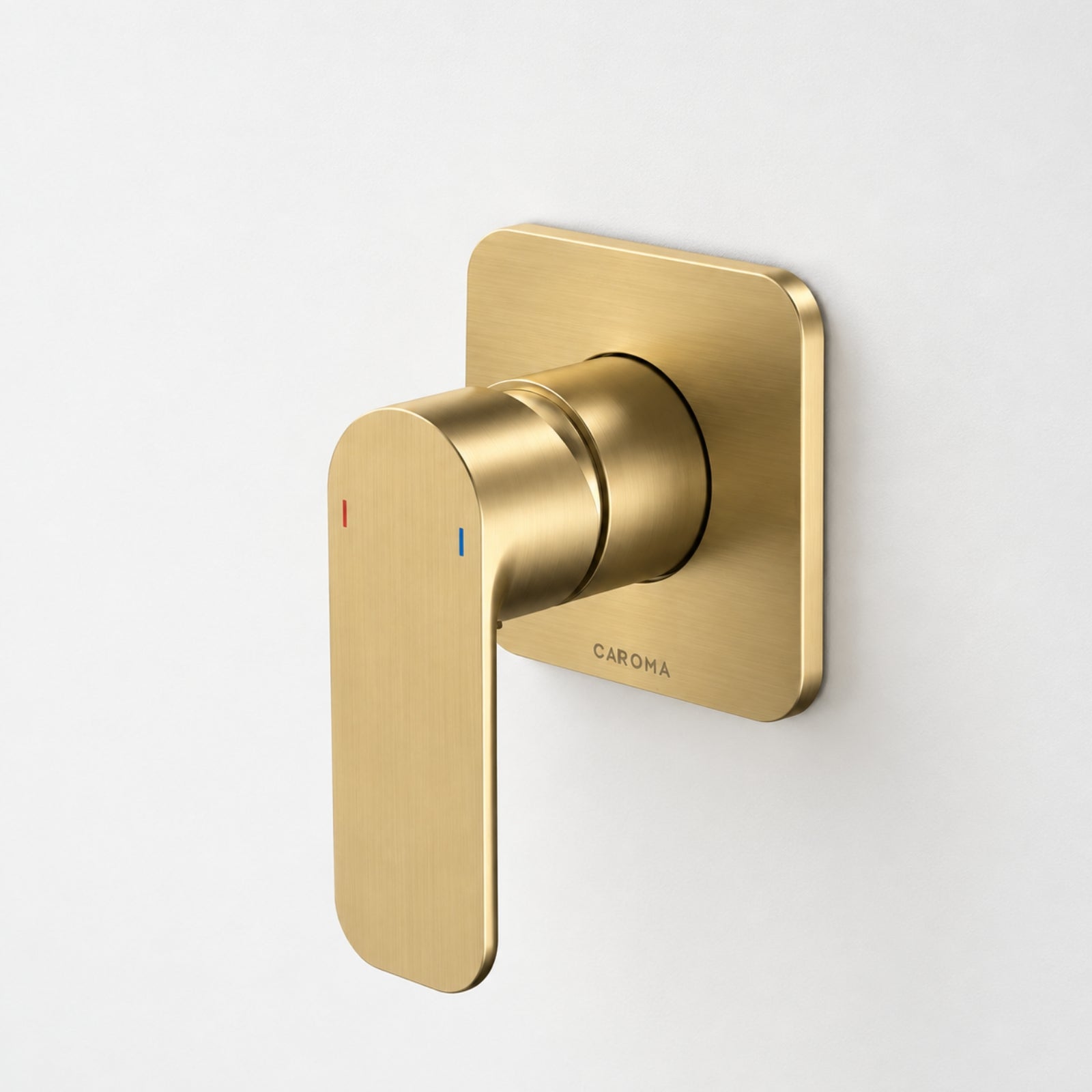 Caroma Luna wall-mounted bath/shower mixer in brushed brass, with square backplate and slim lever handle on white wall