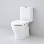 Caroma Luna Cleanflush close coupled toilet suite in white, front view with rimless pan and cistern against a grey wall