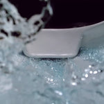 Caroma Luna Cleanflush rimless toilet bowl close-up with water flushing in a white vitreous china finish