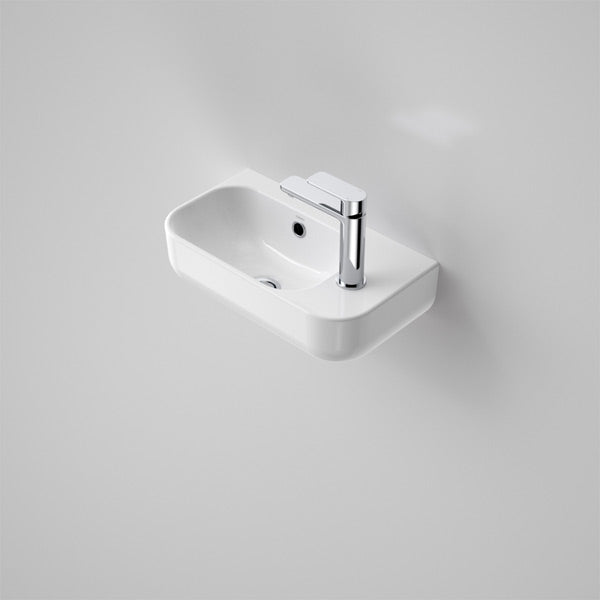 Caroma Luna wall-hung hand basin, gloss white rectangular ceramic, 450mm, with chrome mixer tap in powder room view