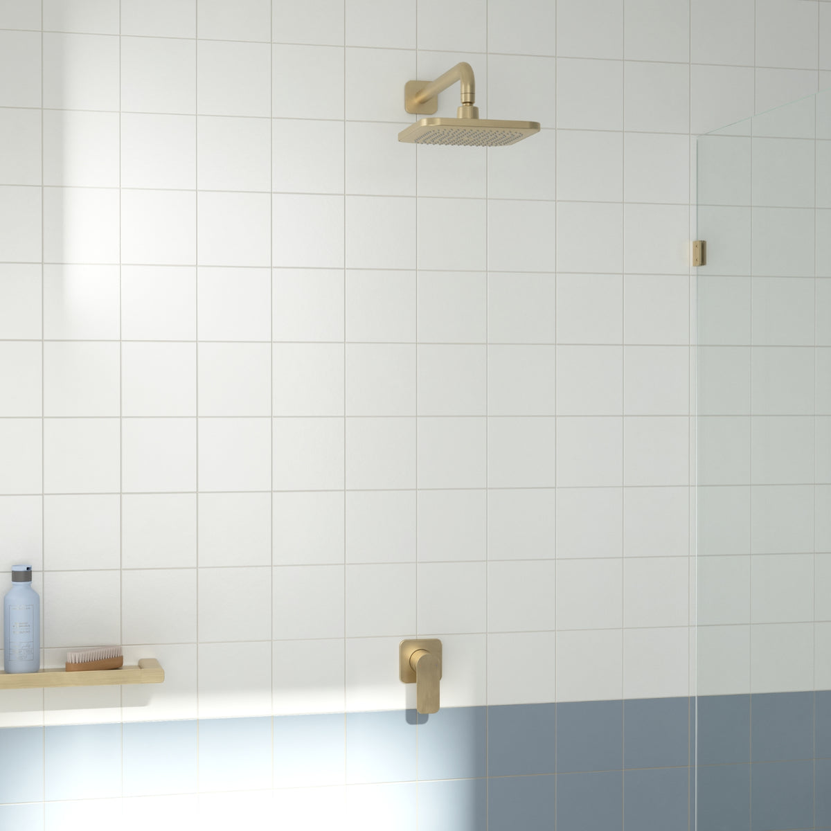 Caroma Luna II brushed brass wall-mounted bath and shower mixer in a tiled bathroom shower setting