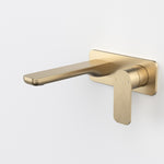 Caroma Luna II wall basin/bath mixer in brushed brass, wall-mounted with flat lever handle and long spout on white background