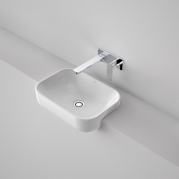 Caroma Luna white gloss semi recessed rectangular basin with wall-mounted chrome mixer, angled view on bench